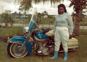 The mature Bessie Stringfield with one of her beloved Harleys in South Florida, from Ann Ferrar Collection. Bessie gifted this photo and many others to Ms. Ferrar, her biographer and friend. Photo is property of the author and must not be used by other parties without prior written permission from Ms. Ferrar.